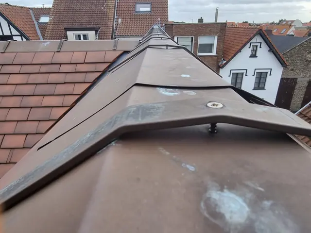 Zinken nokafdekking op een hellend dak
